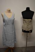 An early 20th century corset in grey and a 1940s camisole in powder blue.