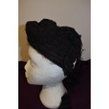 A Victorian bonnet in black with white lace to front band.