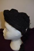 A Victorian bonnet in black with white lace to front band.