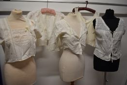 Four Victorian and Edwardian camisoles/ corset covers and a vest.