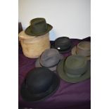 Five vintage trilbies in various colours and a bowler hat.