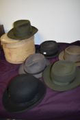 Five vintage trilbies in various colours and a bowler hat.