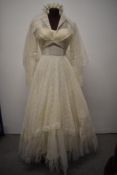 A stunning early 1950s lace wedding dress and jacket with veil and wax flower head dress, dress