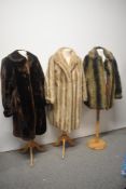 Four vintage faux fur coats in a variety of colours.