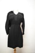 A 1940s black crepe day dress and jacket, dress having button back fastening and beading and fringed