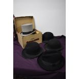 A selection of vintage gents hats, to include boxed Dunn and CO grey top hat, three black bowlers