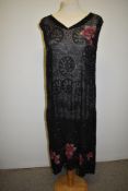 An incredible extensively beaded 1920s Art Deco beaded dress, having pink floral details.