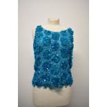 A vintage 1960s aqua blue top, having heavy beading and sequins throughout.