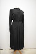 A 1930s black crepe day dress having self covered button fastening to back and side metal zip,
