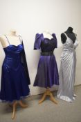 Two prom dresses and a 1980s purple party dress.
