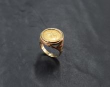 A 9ct gold mounted 1/10 Krugerrand coin ring, dated 1983, within an engine-turned setting and