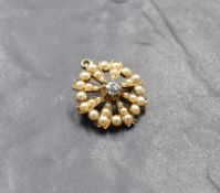 An Edwardian yellow metal pendant/brooch of circular form having a central old cut diamond, approx
