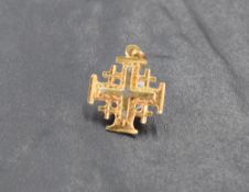 A yellow metal Jerusalem Cross form pendant, marked 18k to reverse and suspension 1.5cm, 1.5grams.