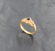 A sapphire and clear stone cluster ring with set cut shoulders on a 22ct gold loop, size M & 3.5g