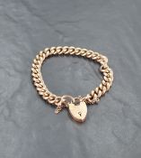 A 9ct gold bracelet, having heart-shaped padlock clasp and curb type links, marked 9 and .375, 42.