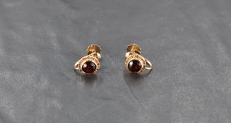 A pair of 9ct gold and garnet screw back earrings, 2.2grams gross