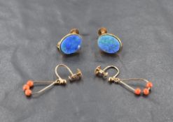 A pair of oval black opal doublet screw back earrings in yellow metal mounts, bearing worn marks,