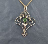 An Edwardian yellow metal pendant stamped 9ct having green paste central gem, on a yellow metal