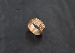 A 9ct gold wedding band, of octagonal form, engraved with foliate detail, marked 375, ring size I,