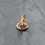 A 9ct rose gold fob modelled as an elf with jet panel to base, approx 3.6g