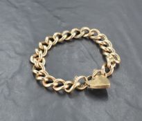 A heavy 9ct gold curb link bracelet with padlock clasp, approx 62g