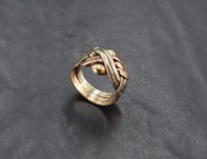 A 9ct tri-colour gold puzzle ring, of Celtic knot design, marked 375 to shank, ring size X, 13.