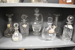 Seven decanters, including cut glass, also included are some decanter tags, Five of which are enamel