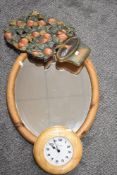 A pine framed oval mirror an ash wood framed clock and a decorated carved wall plaque in plant form