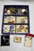 A collection of vintage costume jewellery, including early plastic Art Deco brooches, purple faceted