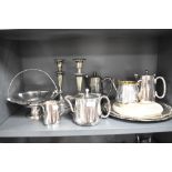 A selection of plated ware, including candlesticks, tray, jugs and more.
