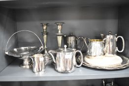A selection of plated ware, including candlesticks, tray, jugs and more.