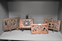 Four antique carved wood panels.