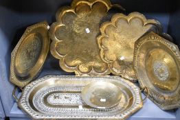 Five vintage Middle Eastern brass trays, having intricate embossed scenes, including elephants, some
