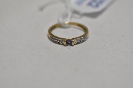 A 9ct gold band ring having small amethyst style stone with diamond chips to shoulders, size L &