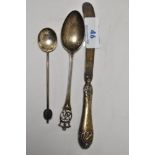 A trio of silver items to include teaspoon, sugar spoon and butter knife.