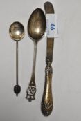A trio of silver items to include teaspoon, sugar spoon and butter knife.