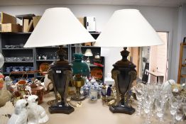 A pair of large reproduction urn style table lamps having goats head design supports, with cream