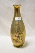 A 1930s Japanese brass vase having embossed monkey and butterfly design.