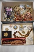 A box of costume jewellery, predominantly vintage beaded necklaces also included are a four hat