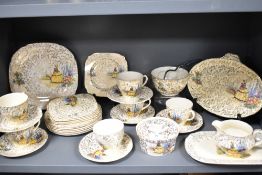 A partial tea service having crinoline lady and garden scenes with gilt detailing, plates, cups