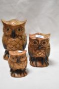 Three graded carved wooden owl studies.