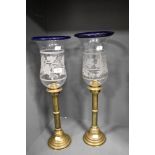 A pair of impressive Victorian brass candlesticks having etched glass shades with vine decoration