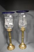 A pair of impressive Victorian brass candlesticks having etched glass shades with vine decoration