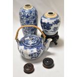 A Ching Dynasty ginger jar on stand with blue snake design, a vase or flask with blue vine