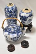 A Ching Dynasty ginger jar on stand with blue snake design, a vase or flask with blue vine