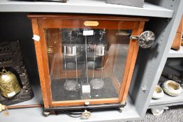 A John. E. Harcourt set of scientific balance scales in fitted glass and mahogany case.
