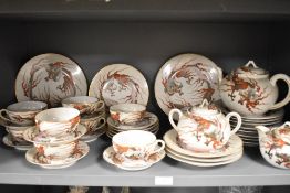 A Japanese eggshell partial tea service having dragon decoration, to include two tea pots, plates,