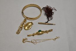 A small lot of gold tone and gold plated jewellery, bangle, brooches and locket to be included.