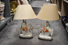 Two Vintage Staffordshire flat back style lamps, depicting gents on horse back, on wooden plinths.