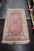A Chineses style G H Prith Ltd Traditional rug in pink, beige and blue tones.